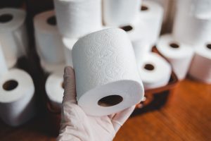 toilet paper with glove by Erik McLean